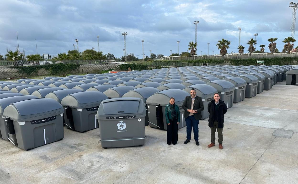 The town's mayor (C) with some of the new waste disposal units. 