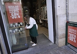 A worker preparing a shop for the sales season.