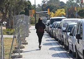 A user rides an electric scooter on the pavement without a helmet on the Costa del Sol.