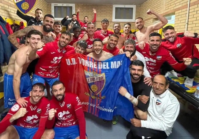The Torre del Mar team celebrate their win in the changing room.