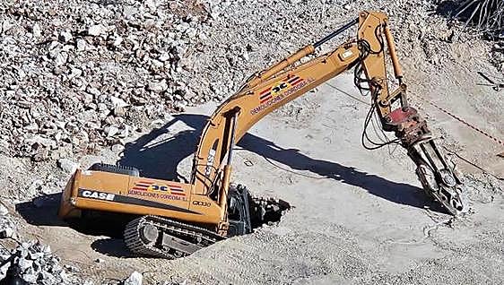 Earth moves for bulldozer driver as machine is swallowed up by ground during demolition of old market in Fuengirola