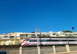 A Cercanias train passes through Torremolinos.