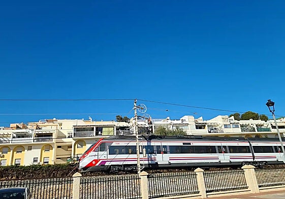 A Cercanias train passes through Torremolinos.