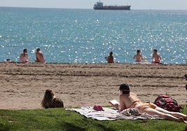 People sunbathing on the beaches of Malaga today, 1 April.