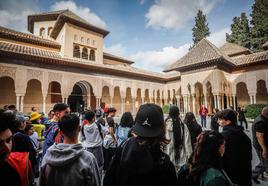 Visitors in the Patio de Los Leones in the Alhambra Palace.