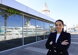 Alejandra Cruces, next to the headquarters of IGY Malaga Marina, whose windows reflect the Lady Moura megayacht.