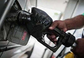 A car filling up with diesel at a fuel pump.