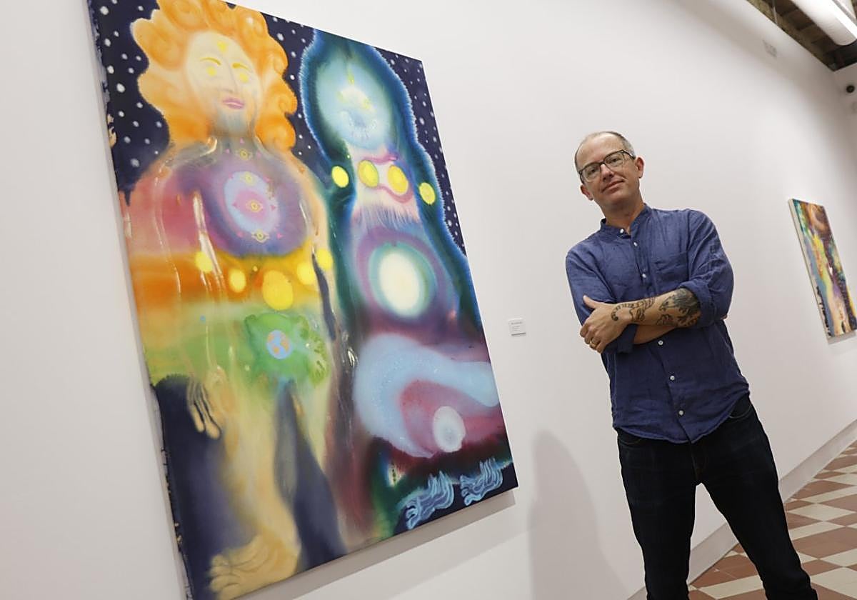 Aaron Johnson next to one of the compositions in his exhibition at La Térmica in Malaga.