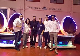 Gordon and Grace with other fairground workers in front of their virtual reality pods.