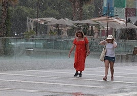 Some tourists caught out in the rain today at Muelle Uno in Malaga city.