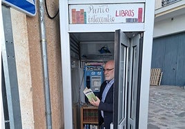 Mayor of Alpujarra de la Sierra José Antonio Gómez inside the library-phone booth.