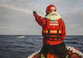 An Aita Mari crew member spots a vessel during a mission in the central Mediterranean.