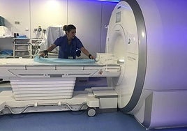 A nurse prepares the tube for a new MRI scan.