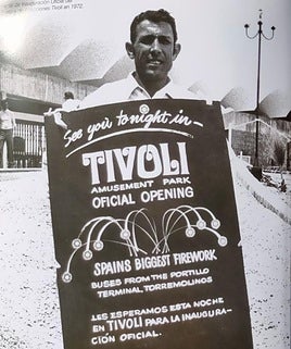 Man wearing a sandwich board announcing the official opening of Tivoli amusement park.