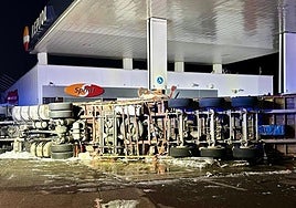 Image of the crashed lorry on the fuel station forecourt.