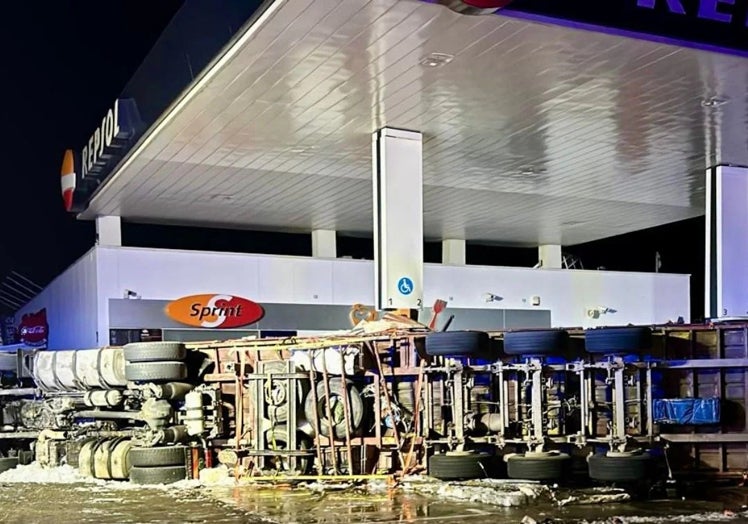 The overturned vehicle came to rest on the forecourt of the motorway service station.