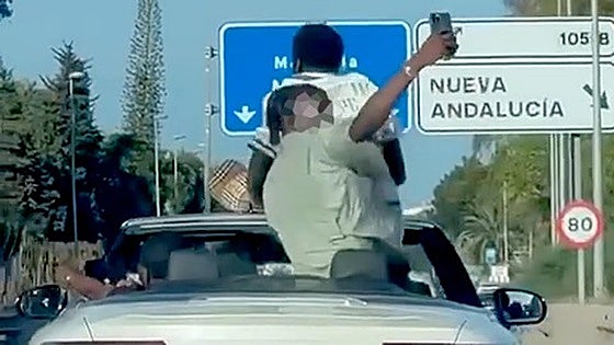 Watch as passengers in two convertibles take 'selfies' standing up while cars speed along Costa del Sol motorway