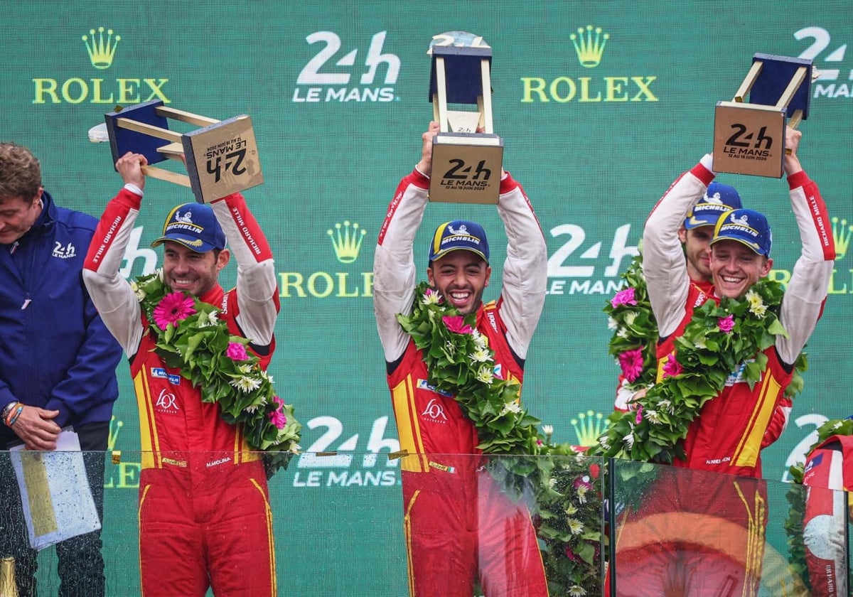 Molina, left, celebrates on the podium with his team.