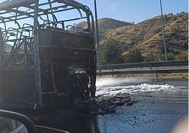 Picture of the completely destroyed bus, taken by a passenger in a passing vehicle.