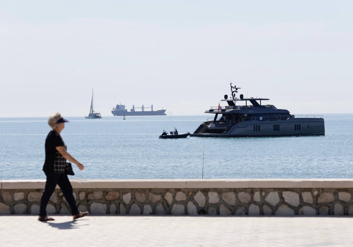 A woman walks along the promenade in Malaga.