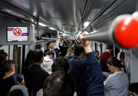 Passengers on board a packed Cercanías train on the Costa del Sol.