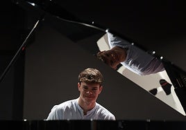 Marcos Castilla seated at the piano in the Interactive Music Museum of Malaga (MIMMA).