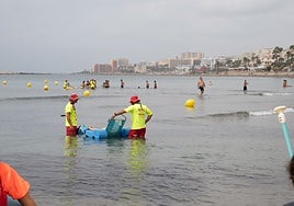 A bather makes use of an amphibious chair.