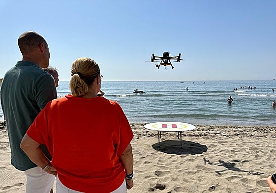 Ana Mula watches one of the drones in action on the beach.
