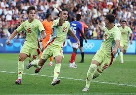 Spain players celebrate an extra time goal.