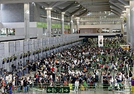 File image of passengers queueing up to check in at Malaga Airport.