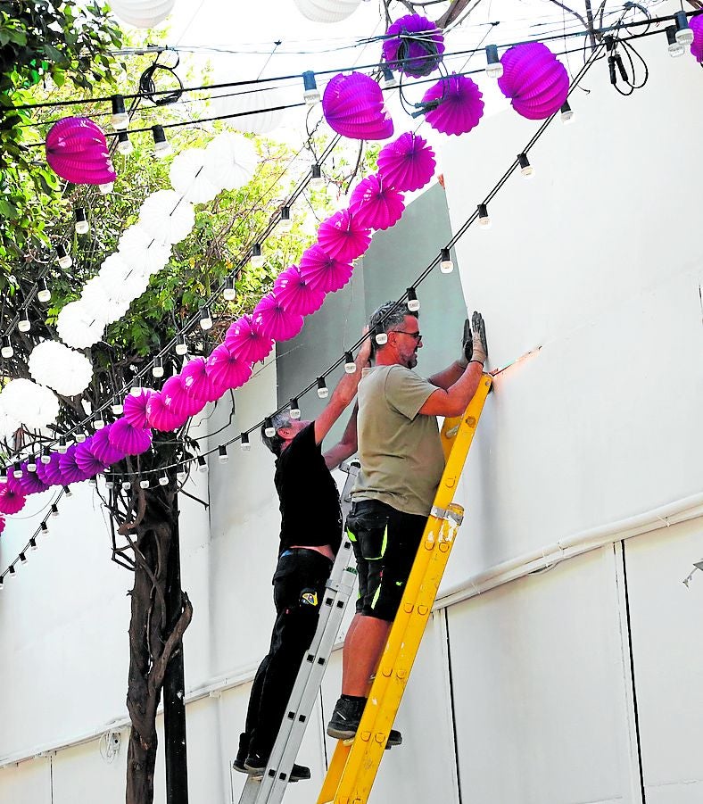 Finishing touches to fairground decorations.
