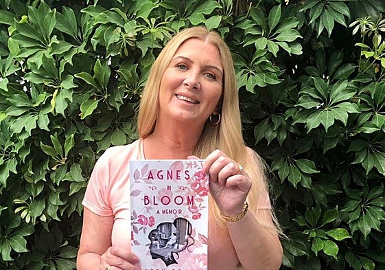 Karen with a copy of her first book, Agnes in Bloom, which received bestseller ratings on Amazon.