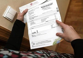 A woman studying her electricity bill.