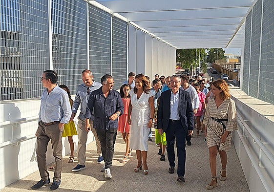 Representatives of the authorities take the first stroll over the new footbridge.
