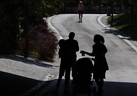 A family out walking sensibly seeks some shade during a heatwave n Spain.