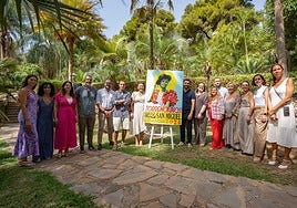 Councillors and the mayor present the poster together with the author of the work.