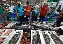 A group of wholesalers looks at the goods before the doors open to shoppers at 5am
