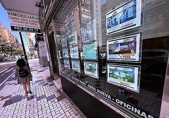 A real estate agency shop window full of advertisements.
