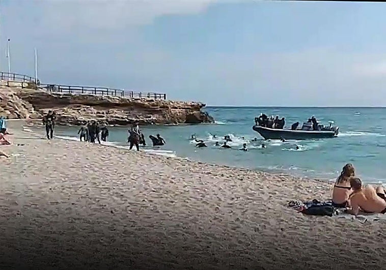 The moment the boat dropped the migrants on the shore before speeding off.
