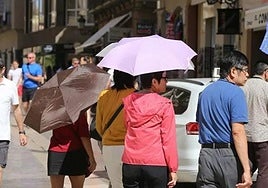 Tourists protect themselves from the sun in Malaga city.