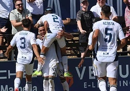 The players rush to celebrate Callejón's winning goal.