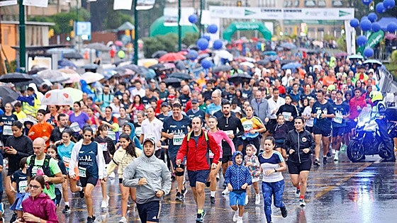 Just 3,000 runners out of 10,000 registered cross the line in rain-soaked Carrera Urbana in Malaga