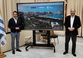 Florido and Gómez explaining the promotional display that will be featured in London.