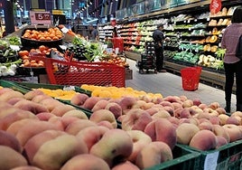 Shoppers in the fruit and veg section of a supermarket.