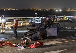 The car in which the two deceased were travelling in the foreground, and the boat in the background.