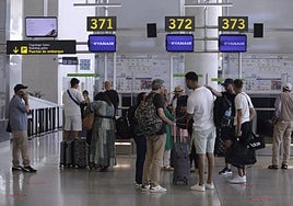 Ryanair agrees to refund 55 euros to around 100,000 passengers for check-in charges it imposed at airports