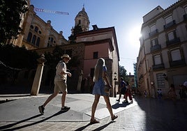Tourists discover the historic centre of Malaga.