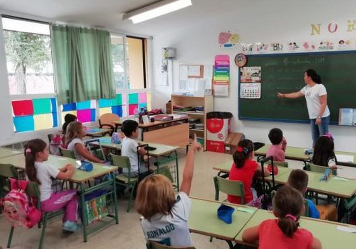 Teacher and pupils hard at work in a classroom.