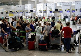 Passengers wait to check in their luggage at Malaga Airport (file image).