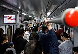 Passengers packed on a Cercanías C1 commuter train running between Malaga and Fuengirola on the Costa del Sol.